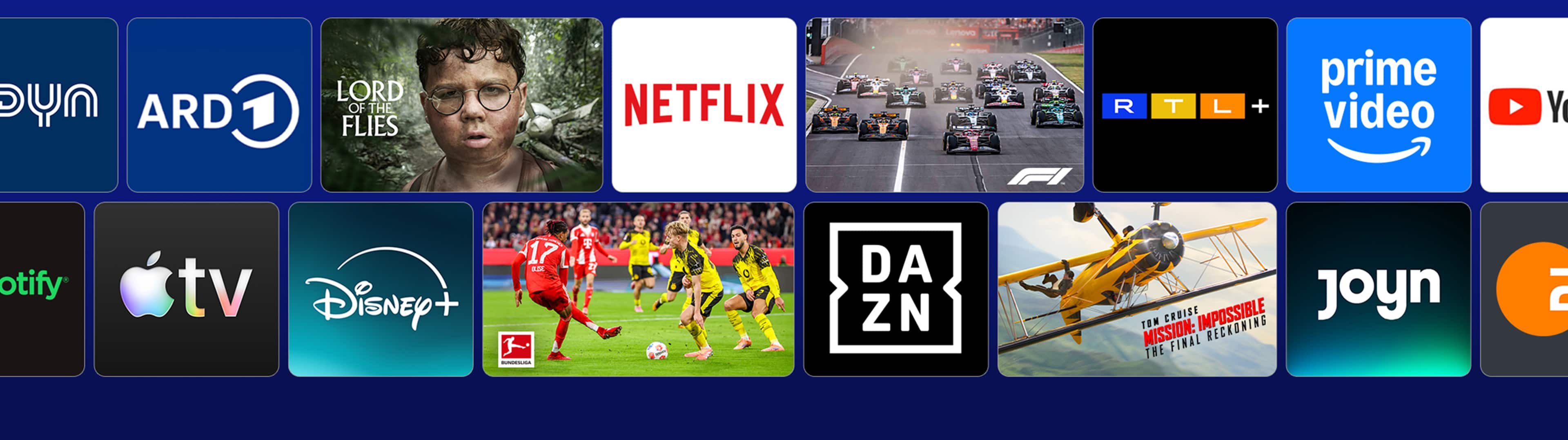 Startbildschirm einer Smart-TV-Streamingoberfläche mit App-Kacheln und Inhaltsempfehlungen. Sichtbar sind unter anderem ARD, Netflix, RTL+, Prime Video, Apple TV, Disney+, DAZN und Joyn. Dazwischen werden Inhalte wie die Serie „The Rookie“, ein Formel-1-Rennen, ein Bundesliga-Fußballspiel sowie der Film „Jurassic World: Die Wiedergeburt“ hervorgehoben.